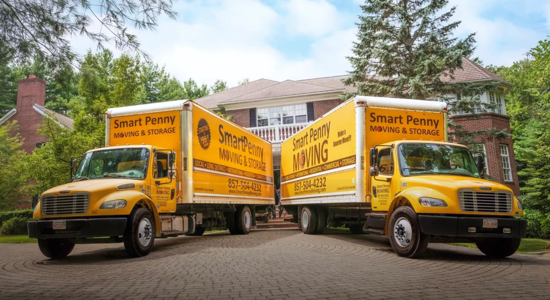 Two Smart Penny Moving trucks parked in front of a house
